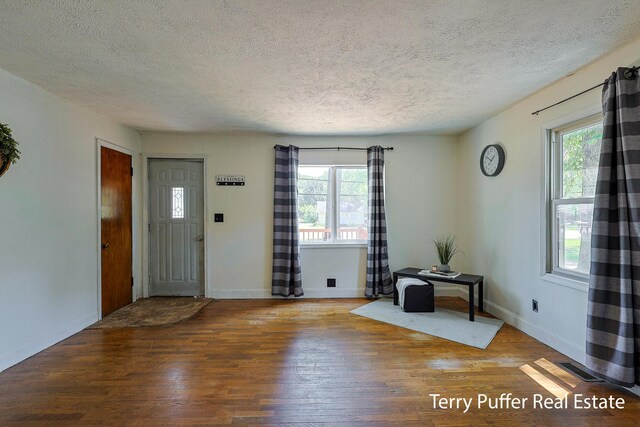 2025 Whitehall Rd, Muskegon, MI 49445 - entrance foyer with a textured ceiling and wood-type flooring