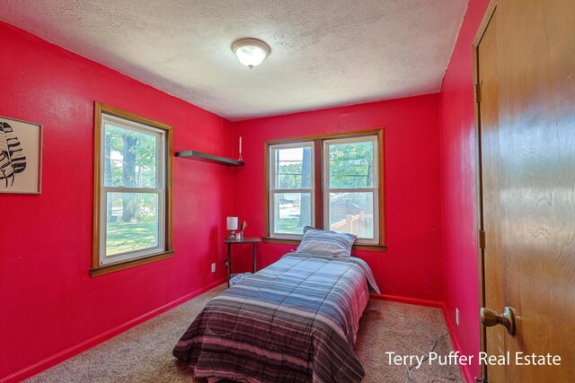 2025 Whitehall Rd, Muskegon, MI 49445 - carpeted bedroom featuring a textured ceiling and baseboards