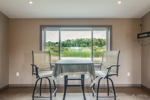 4646 Lehman Rd, West Branch, MI 48661 - dining room featuring recessed lighting, healthy amount of natural light, and concrete floors