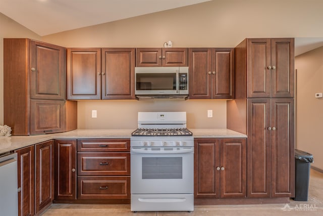 4646 Lehman Rd, West Branch, MI 48661 - kitchen featuring stainless steel microwave, gas range gas stove, lofted ceiling, and dishwasher
