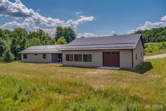 4646 Lehman Rd, West Branch, MI 48661 - rear view of property with a lawn and a garage