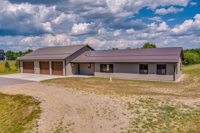 4646 Lehman Rd, West Branch, MI 48661 - view of front of house featuring dirt driveway, an attached garage, a metal roof, and a front yard