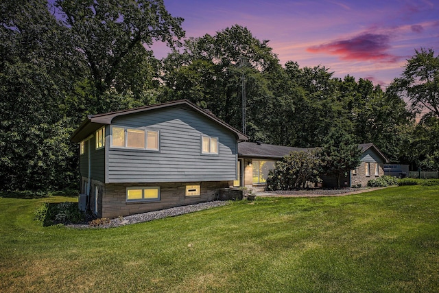 929 N Park Rd, Benton Harbor, MI 49022 - back of house at dusk with a yard