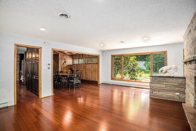 929 N Park Rd, Benton Harbor, MI 49022 - dining area featuring a textured ceiling, a fireplace, wood finished floors, recessed lighting, and a baseboard heating unit