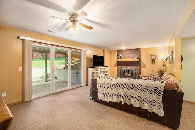 1972 Red Pine Dr, Dorr, MI 49323 - carpeted living area featuring a brick fireplace and ceiling fan