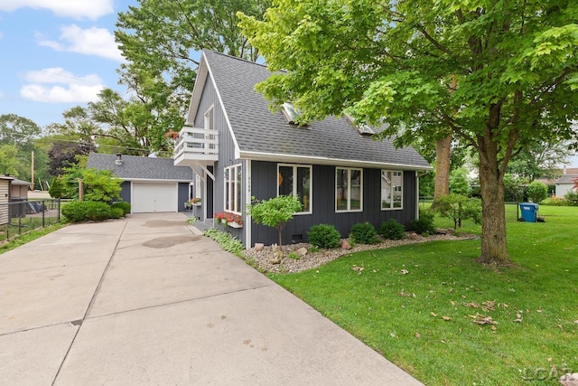 3129 Oakshade Dr, Manitou Beach, MI 49253 - view of front of house with concrete driveway, a shingled roof, a garage, a balcony, and board and batten siding