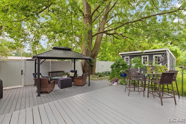 3129 Oakshade Dr, Manitou Beach, MI 49253 - wooden deck with an outdoor hangout area, a fenced backyard, a gazebo, and outdoor dining space