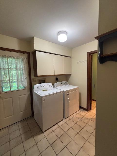 43618 Carla Dr, Paw Paw, MI 49079 - laundry room featuring cabinet space, light tile patterned floors, and washing machine and clothes dryer