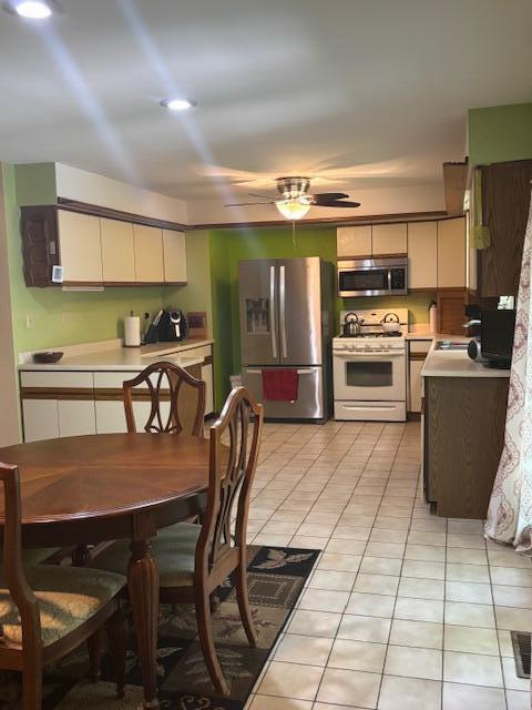 43618 Carla Dr, Paw Paw, MI 49079 - kitchen with appliances with stainless steel finishes, light tile patterned floors, light countertops, and a ceiling fan