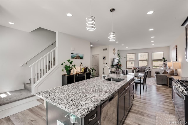5973 Stella, Troy, MI 48085 - kitchen featuring stainless steel appliances, recessed lighting, light wood-type flooring, decorative light fixtures, and open floor plan