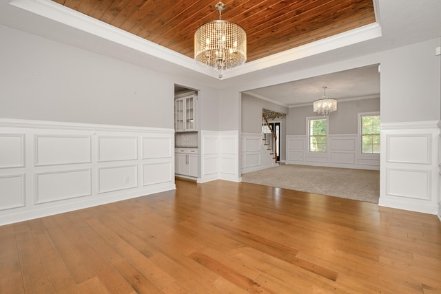 7226 Breton Woods Ct, Kalamazoo, MI 49009 - spare room featuring a chandelier, a raised ceiling, stairway, hardwood / wood-style flooring, and wood ceiling