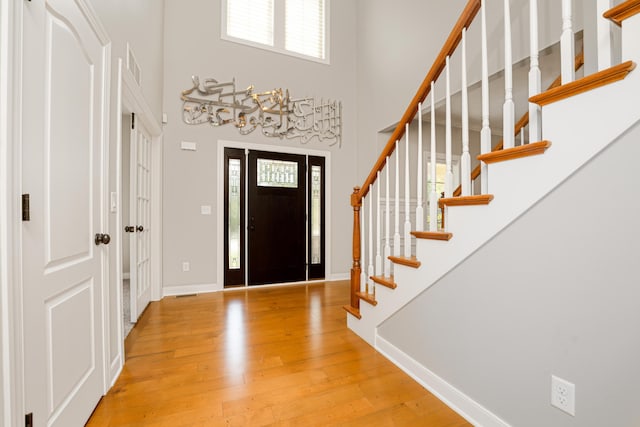 7226 Breton Woods Ct, Kalamazoo, MI 49009 - foyer entrance with wood finished floors, a towering ceiling, and stairway