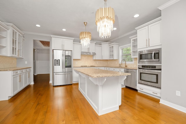 7226 Breton Woods Ct, Kalamazoo, MI 49009 - kitchen featuring stainless steel appliances, decorative backsplash, a chandelier, a kitchen island, and light wood-type flooring