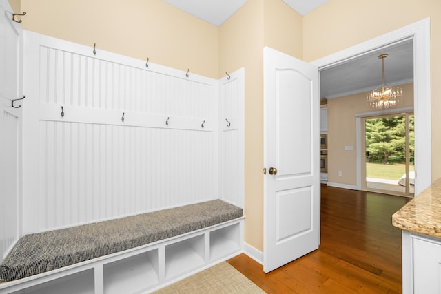 7226 Breton Woods Ct, Kalamazoo, MI 49009 - mudroom with a chandelier, wood finished floors, and ornamental molding