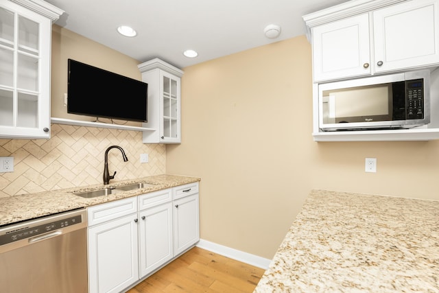 7226 Breton Woods Ct, Kalamazoo, MI 49009 - kitchen featuring appliances with stainless steel finishes, light wood-type flooring, tasteful backsplash, white cabinets, and glass insert cabinets