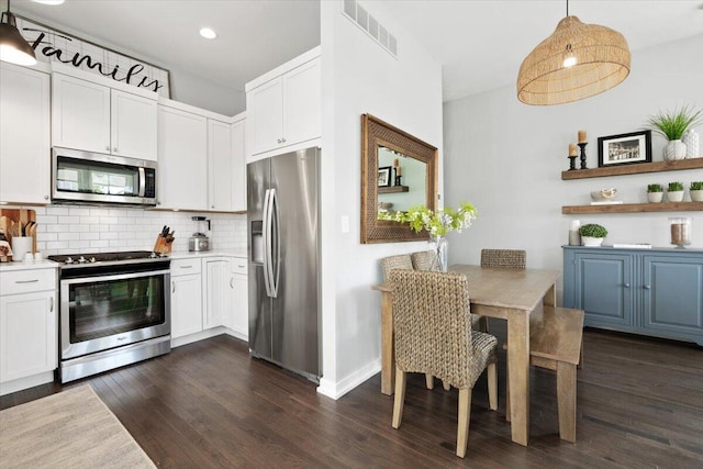 230 Cavelier Ave, Saint Joseph, MI 49085 - kitchen featuring stainless steel appliances, decorative backsplash, dark wood-type flooring, white cabinets, and recessed lighting