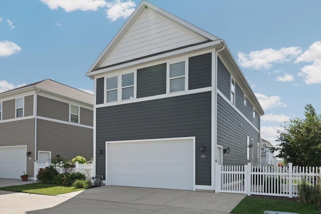 230 Cavelier Ave, Saint Joseph, MI 49085 - view of front of house featuring an attached garage and driveway