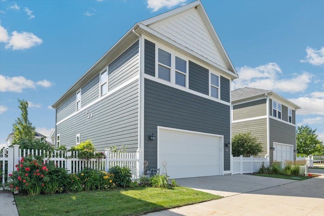 230 Cavelier Ave, Saint Joseph, MI 49085 - view of side of property featuring a garage and concrete driveway