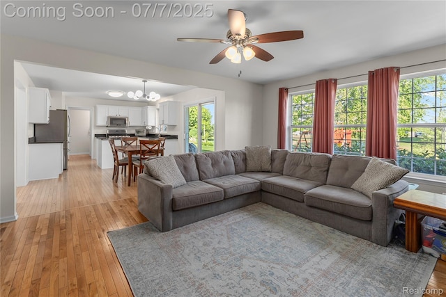 48840 Greenwich Cir, Canton, MI 48188 - living room with a ceiling fan, light wood-type flooring, and healthy amount of natural light