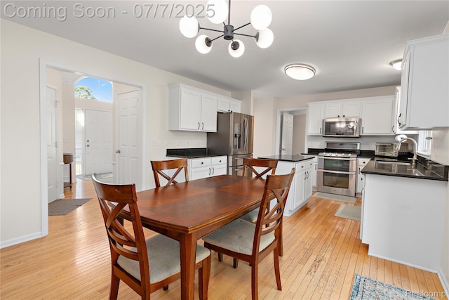 48840 Greenwich Cir, Canton, MI 48188 - dining room featuring light wood-style flooring and a chandelier