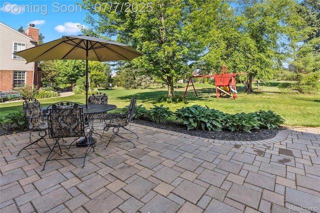 48840 Greenwich Cir, Canton, MI 48188 - view of patio featuring a playground and outdoor dining space