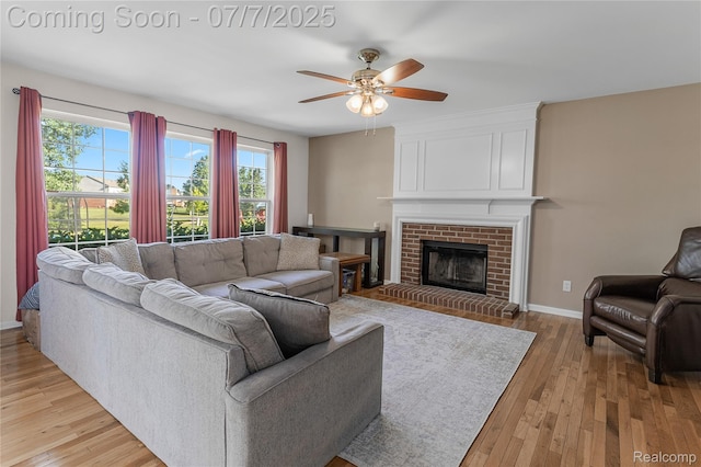 48840 Greenwich Cir, Canton, MI 48188 - living area with light wood finished floors, ceiling fan, and a brick fireplace