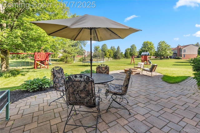 48840 Greenwich Cir, Canton, MI 48188 - view of patio / terrace with a playground, a trampoline, an outdoor fire pit, and outdoor dining space
