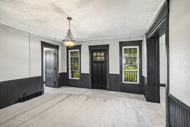 238 Maple Rd, Quincy, MI 49082 - carpeted foyer entrance with wainscoting and a textured wall