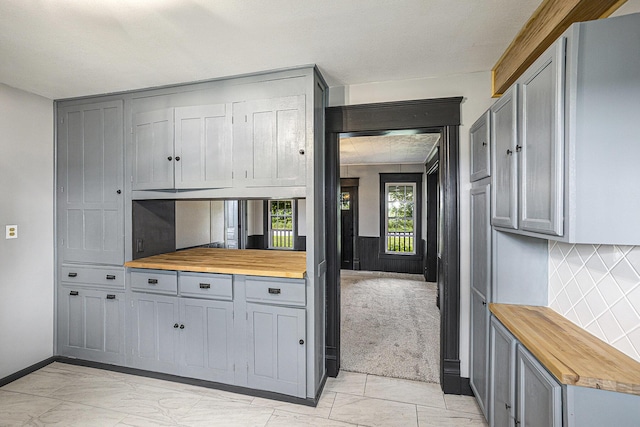 238 Maple Rd, Quincy, MI 49082 - kitchen with wooden counters, gray cabinets, and decorative backsplash