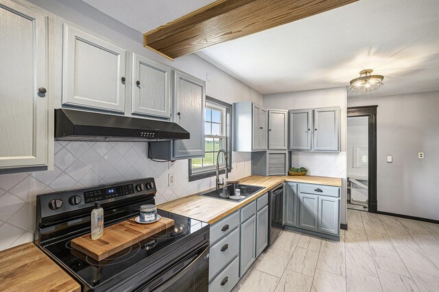 238 Maple Rd, Quincy, MI 49082 - kitchen featuring black electric range, under cabinet range hood, butcher block counters, gray cabinets, and decorative backsplash