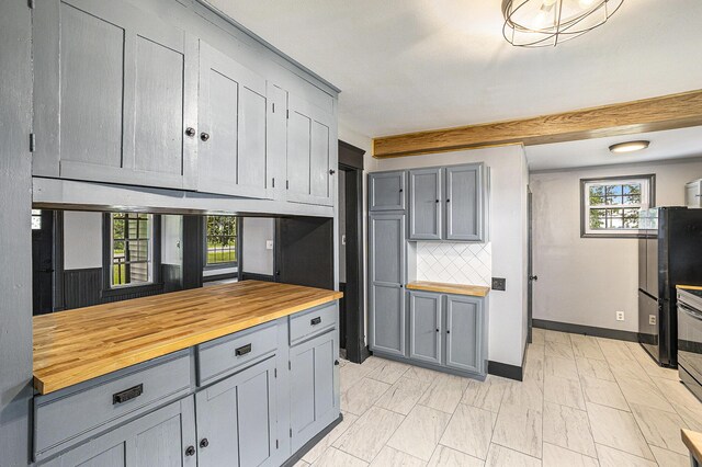 238 Maple Rd, Quincy, MI 49082 - kitchen with wood counters and gray cabinets