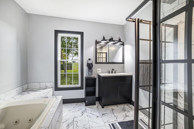 238 Maple Rd, Quincy, MI 49082 - bathroom featuring marble finish floors, vanity, and a jetted tub