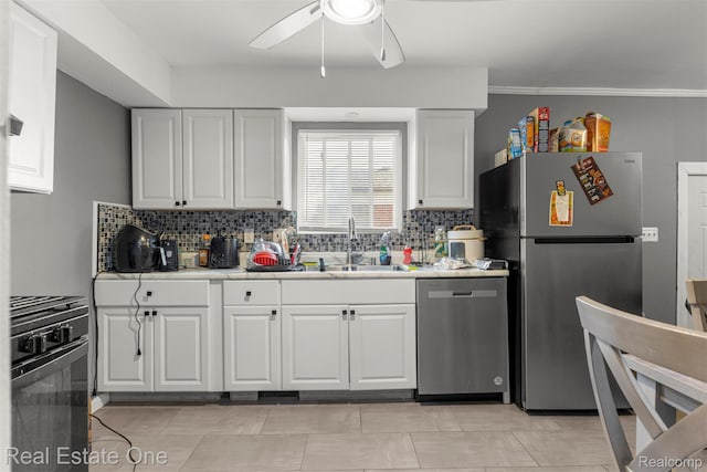 496 Lenoir Ave, River Rouge, MI 48218 - kitchen with appliances with stainless steel finishes, a ceiling fan, white cabinets, backsplash, and tile counters