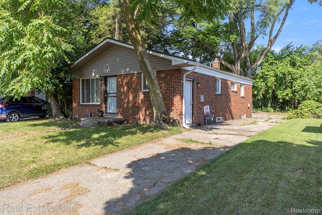 496 Lenoir Ave, River Rouge, MI 48218 - bungalow-style home with brick siding, a chimney, and a front lawn