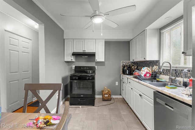 496 Lenoir Ave, River Rouge, MI 48218 - kitchen with stainless steel dishwasher, gas stove, under cabinet range hood, white cabinetry, and a ceiling fan