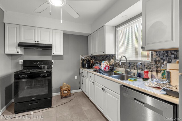 496 Lenoir Ave, River Rouge, MI 48218 - kitchen with black gas stove, under cabinet range hood, stainless steel dishwasher, a ceiling fan, and backsplash