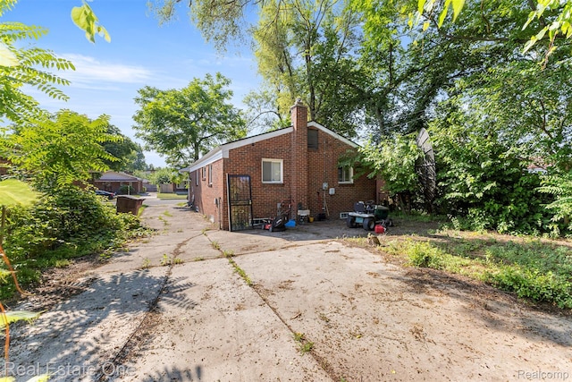 496 Lenoir Ave, River Rouge, MI 48218 - view of home's exterior featuring brick siding and a chimney