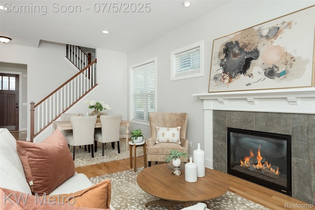 3666 Phillips Ave, Berkley, MI 48072 - living area featuring wood finished floors, stairway, healthy amount of natural light, a fireplace, and recessed lighting