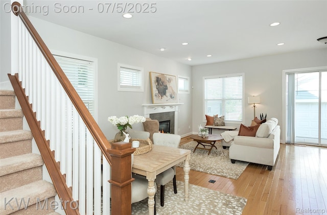 3666 Phillips Ave, Berkley, MI 48072 - living room with light wood finished floors, stairs, a glass covered fireplace, and recessed lighting