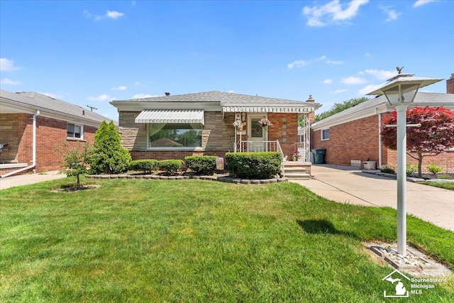 1534 London St, Lincoln Park, MI 48146 - view of front of home with a front yard and brick siding