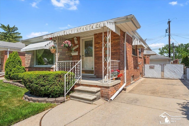 1534 London St, Lincoln Park, MI 48146 - view of front of property featuring brick siding, a garage, and an outdoor structure