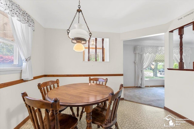 1534 London St, Lincoln Park, MI 48146 - carpeted dining space featuring baseboards and a chandelier