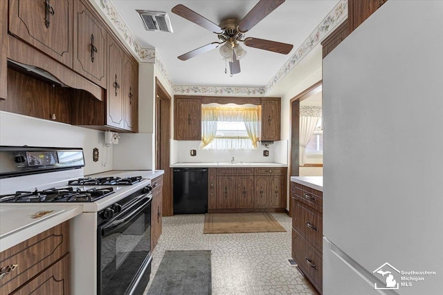 1534 London St, Lincoln Park, MI 48146 - kitchen featuring freestanding refrigerator, gas stove, black dishwasher, light countertops, and ceiling fan