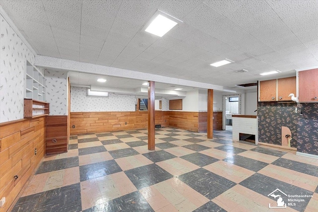 1534 London St, Lincoln Park, MI 48146 - basement featuring a wainscoted wall, tile patterned floors, wood walls, and wallpapered walls