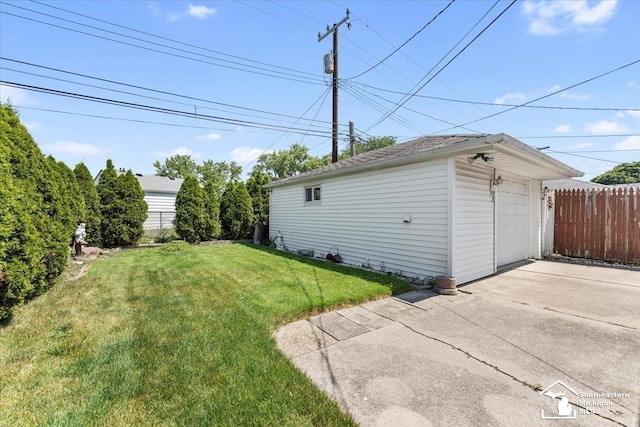 1534 London St, Lincoln Park, MI 48146 - view of yard featuring a detached garage, an outbuilding, and driveway