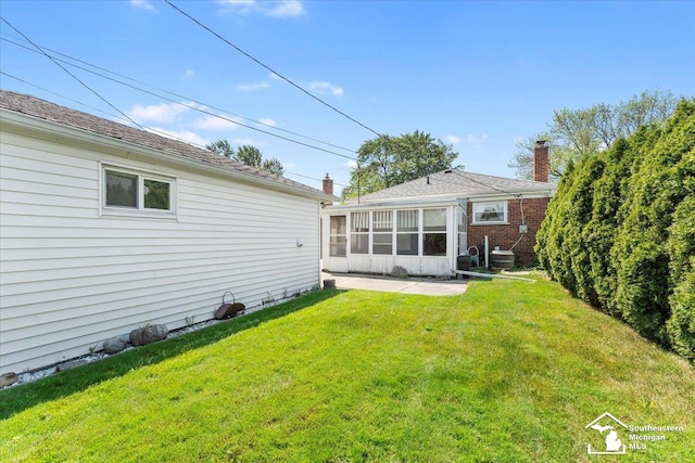 1534 London St, Lincoln Park, MI 48146 - rear view of house with a yard and a sunroom