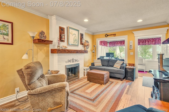 1726 Oxford Rd, Berkley, MI 48072 - living room featuring wood finished floors, a fireplace, ornamental molding, a textured ceiling, and recessed lighting