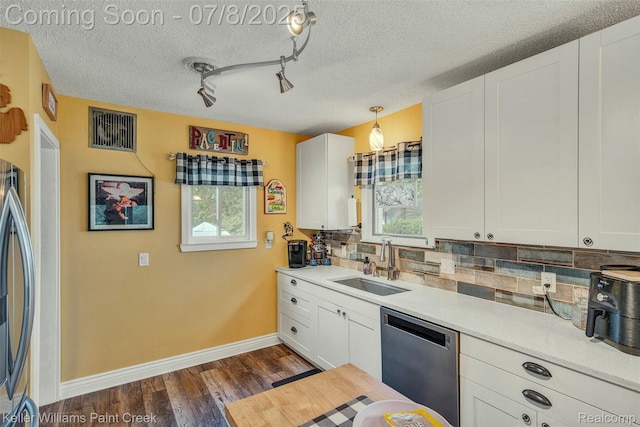 1726 Oxford Rd, Berkley, MI 48072 - kitchen with stainless steel dishwasher, plenty of natural light, backsplash, dark wood-style floors, and a textured ceiling