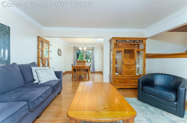 8527 Congress Dr, Canton, MI 48187 - living room featuring light wood-type flooring, ornamental molding, and a chandelier