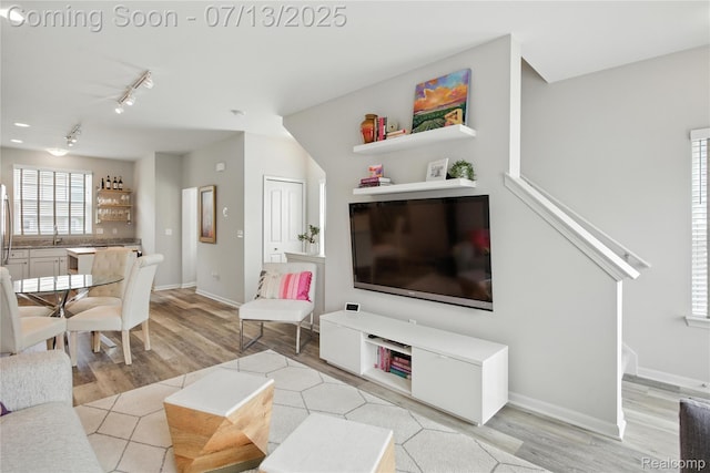 3317 Parkways Blvd, Auburn Hills, MI 48326 - living room with light wood-style floors, track lighting, and stairway